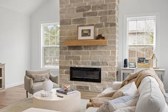 a living room with furniture window and a fireplace
