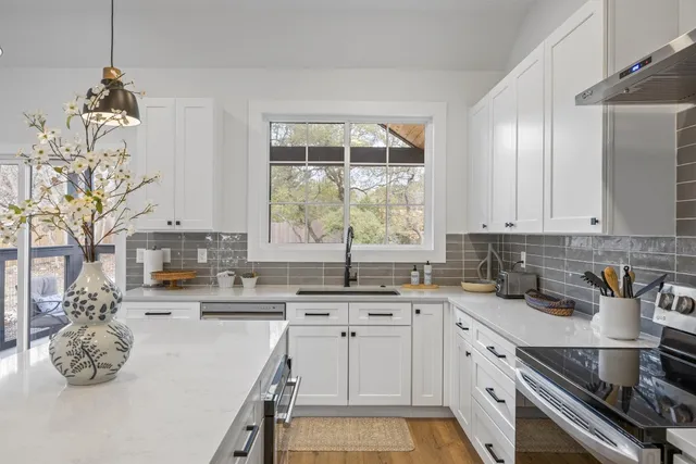 a kitchen with a sink stove and cabinets
