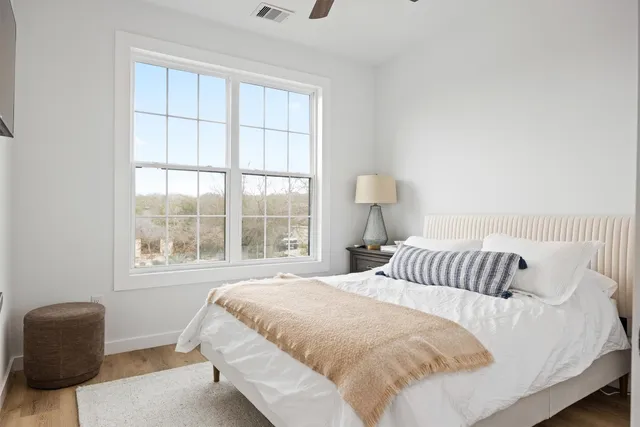 a bedroom with a bed and a chair