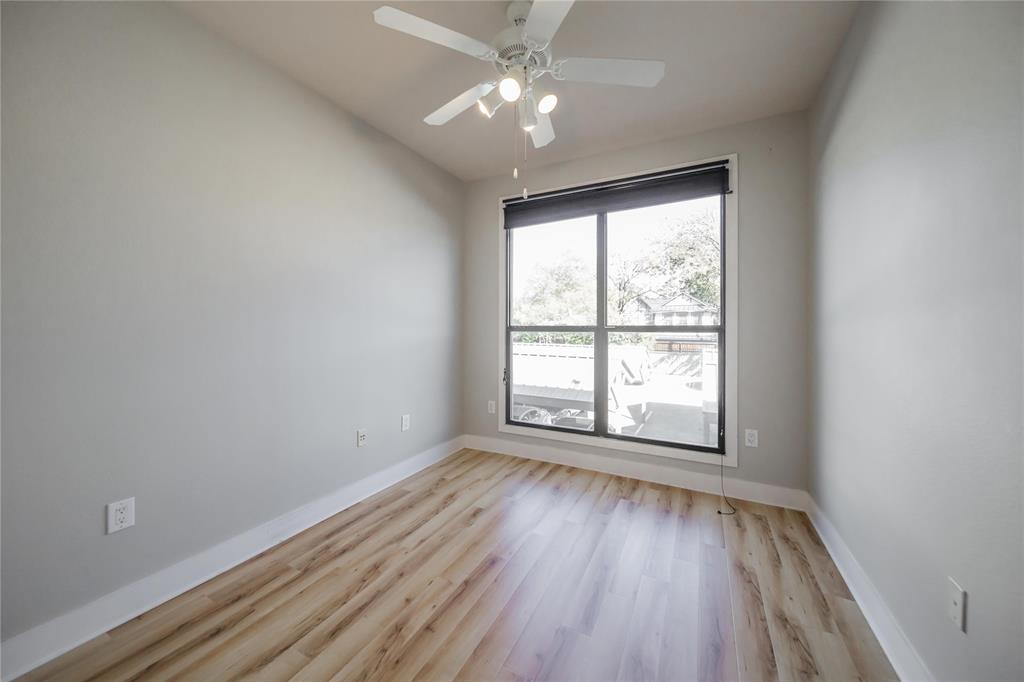 4414 Cedar Springs Road, Unit 214 Dallas, TX 75219 - Photo 14 of 29 Empty room with light wood-style floors and a ceiling fan