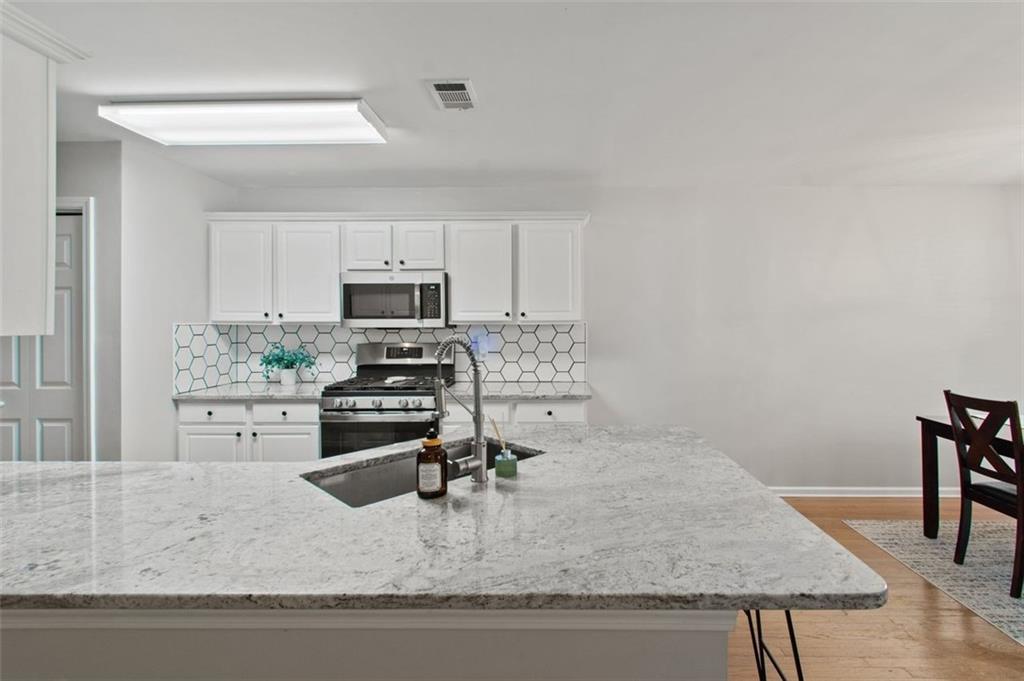 2907 Albright Commons Kennesaw, GA 30144 - Photo 11 of 35 a kitchen with a stove a sink and a refrigerator