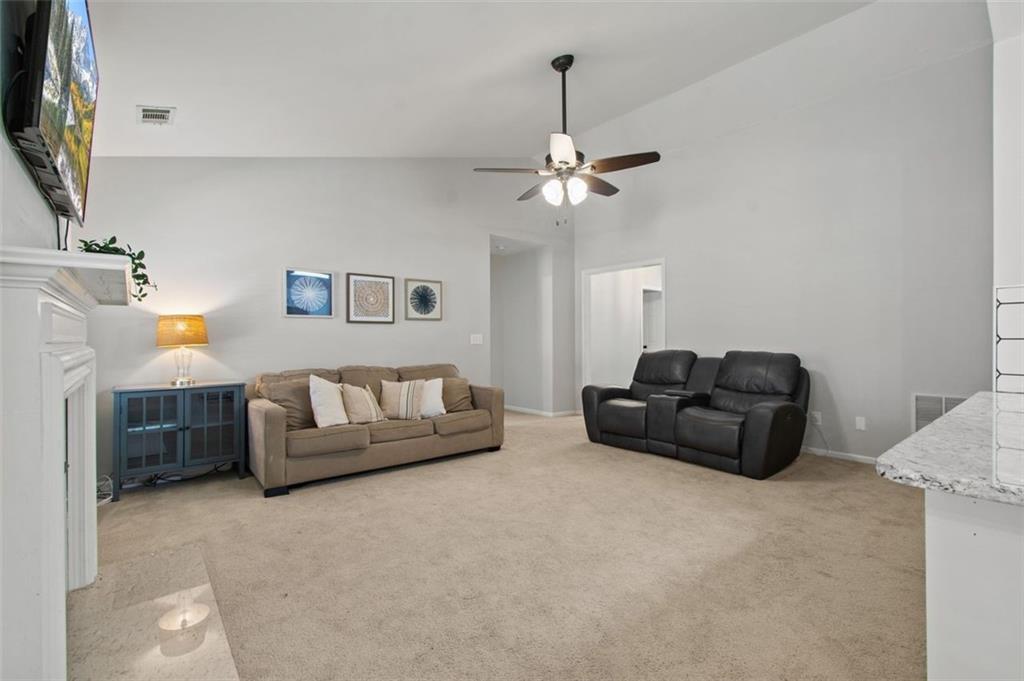 2907 Albright Commons Kennesaw, GA 30144 - Photo 12 of 35 a living room with furniture and a chandelier