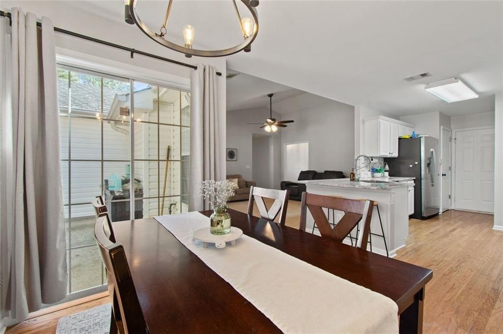 2907 Albright Commons Kennesaw, GA 30144 - Photo 13 of 35 a view of a dining room with furniture window and wooden floor