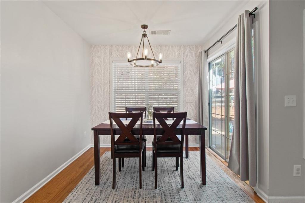 2907 Albright Commons Kennesaw, GA 30144 - Photo 14 of 35 a view of a dining room with furniture window and wooden floor