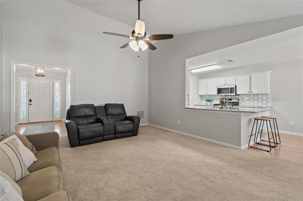 2907 Albright Commons Kennesaw, GA 30144 - Photo 15 of 35 a living room with furniture and a chandelier