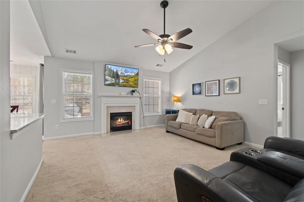2907 Albright Commons Kennesaw, GA 30144 - Photo 16 of 35 a living room with furniture a fireplace and a flat screen tv