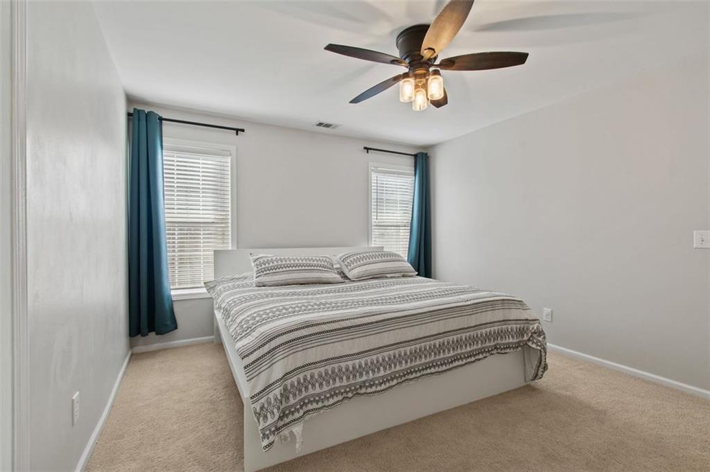 2907 Albright Commons Kennesaw, GA 30144 - Photo 21 of 35 a bedroom with a bed and a ceiling fan