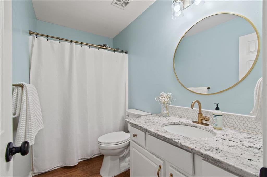 2907 Albright Commons Kennesaw, GA 30144 - Photo 26 of 35 a bathroom with a granite countertop sink toilet and a mirror