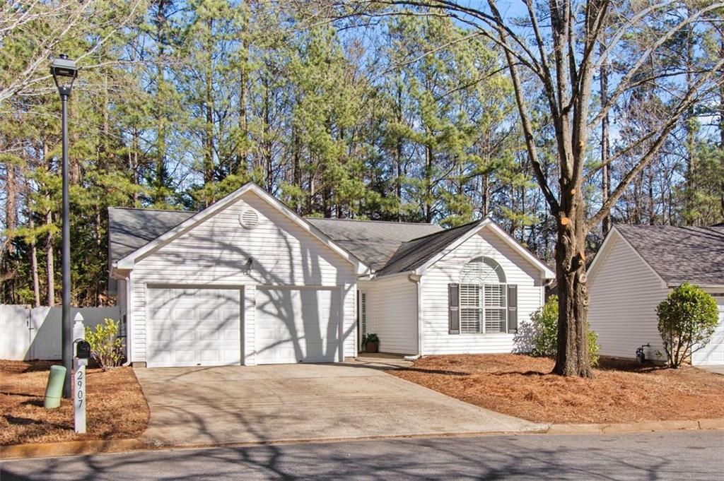 2907 Albright Commons Kennesaw, GA 30144 - Photo 34 of 35 a front view of a house with a yard and garage
