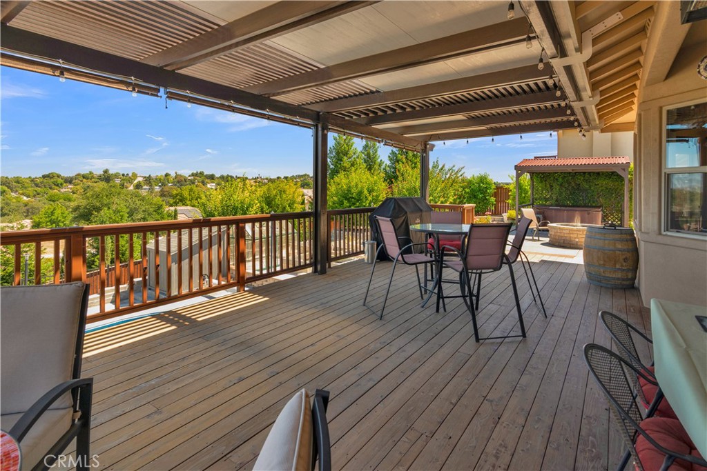 654 Red Cloud Road Paso Robles, CA 93446 - Photo 3 of 46 a view of a roof deck with dining table and chairs with wooden floor