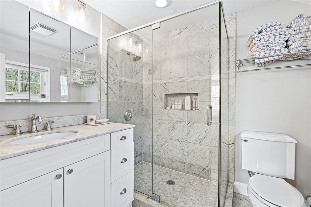 24 Cider Mill Road Framingham, MA 01701 - Photo 13 of 19 a bathroom with a granite countertop sink a toilet and shower