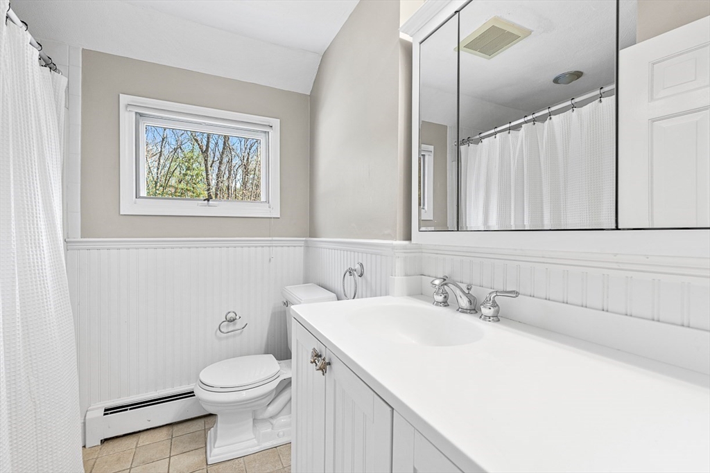 24 Cider Mill Road Framingham, MA 01701 - Photo 15 of 19 a bathroom with a toilet sink and mirror
