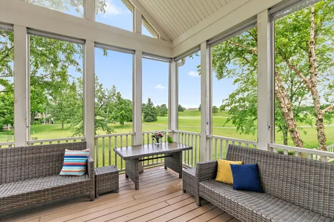 a balcony with wooden floor and furniture