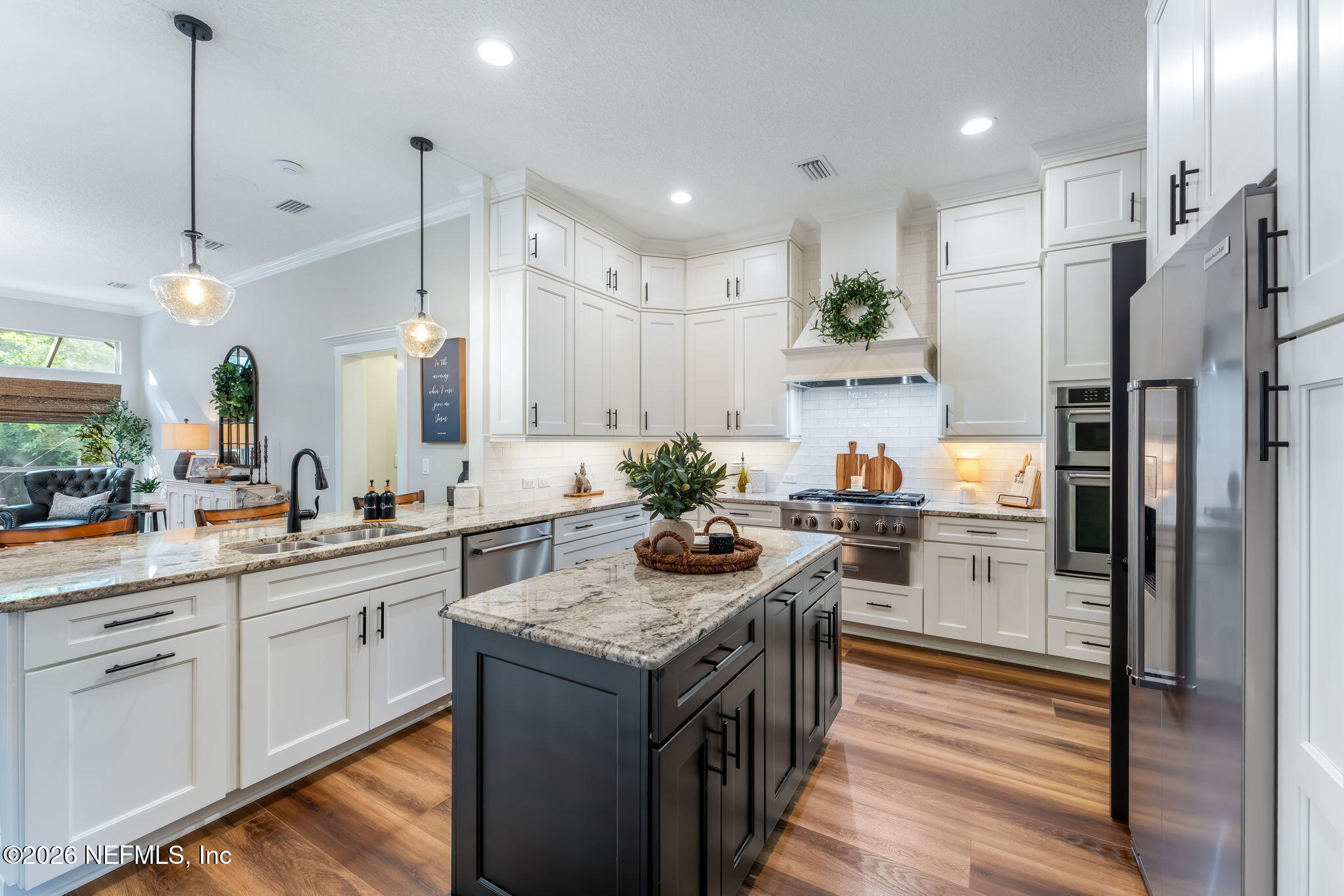 1204 Creek Bend Road St. Johns, FL 32259 - Photo 21 of 107 a kitchen with stainless steel appliances granite countertop a refrigerator a sink dishwasher a stove and white cabinets with wooden floor
