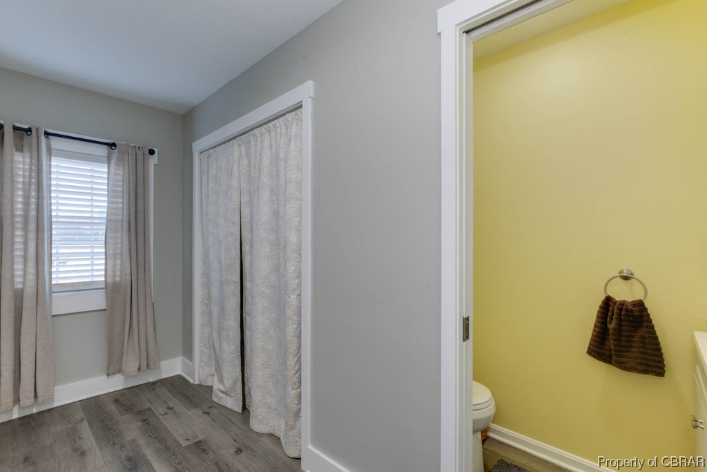 8714 Guinea Road Hayes, VA 23072 - Photo 19 of 44 Bathroom with hardwood / wood-style floors and toilet