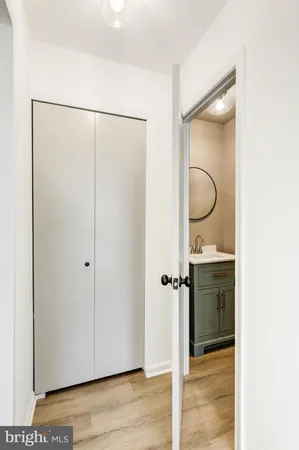 a bathroom with a granite countertop shower sink and mirror