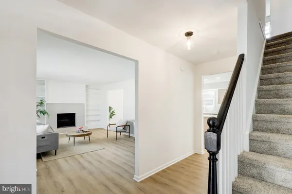 a view of a livingroom with wooden floor and furniture