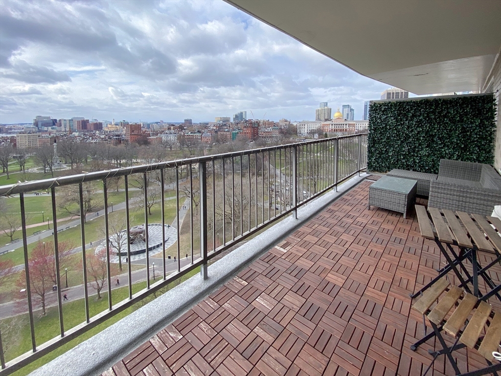 a view of roof deck with wooden floor and fence