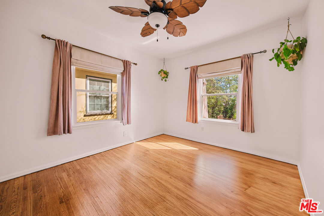 592 Figueroa Drive Altadena, CA 91001 - Photo 12 of 19 a view of an empty room with a window and wooden floor
