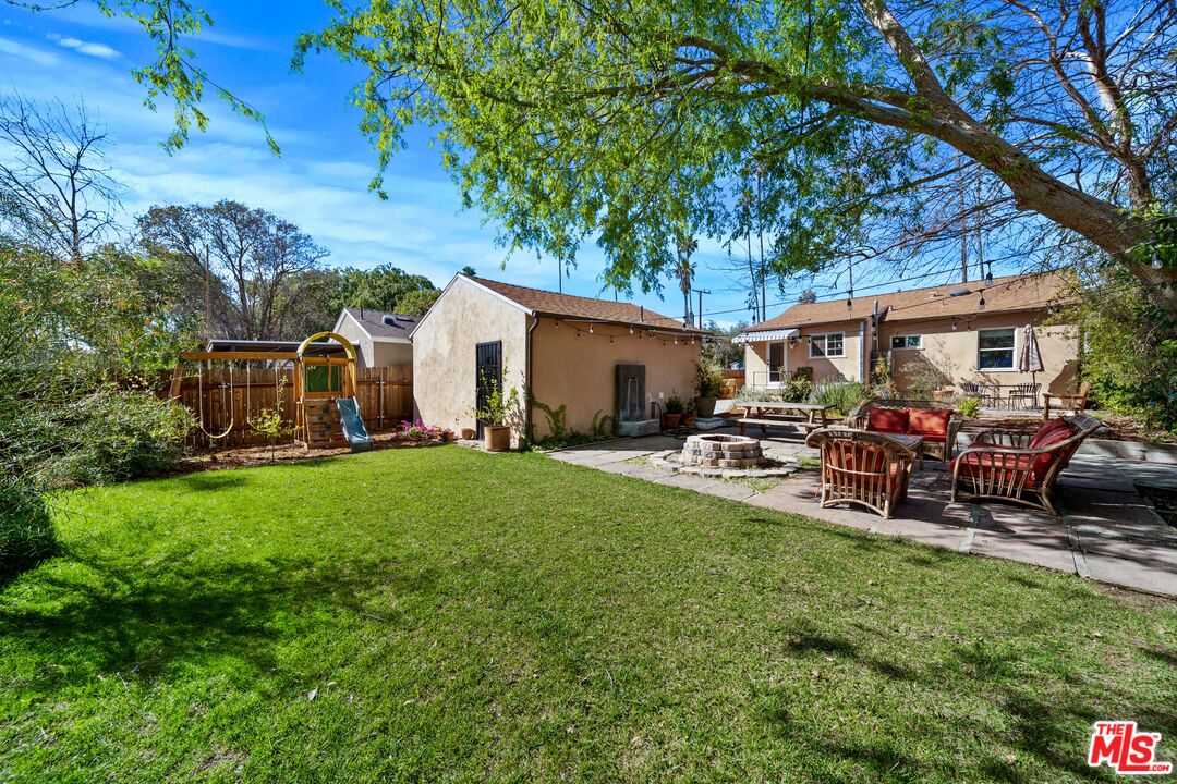 592 Figueroa Drive Altadena, CA 91001 - Photo 19 of 19 a view of a patio with table and chairs potted plants and a large tree