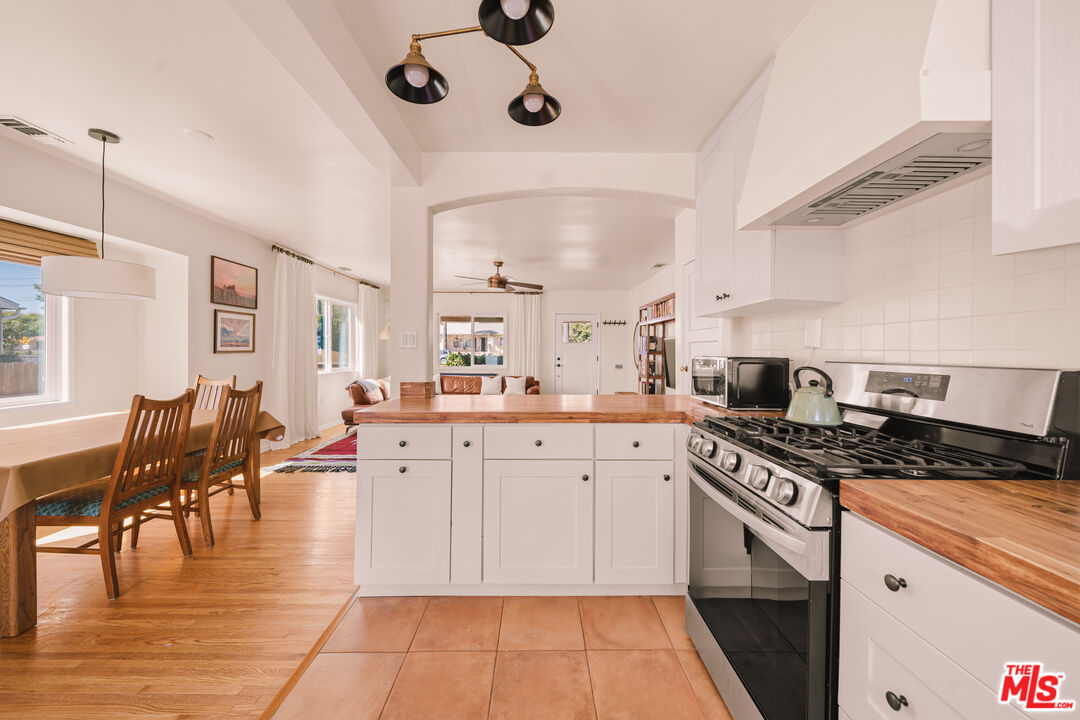 592 Figueroa Drive Altadena, CA 91001 - Photo 6 of 19 a kitchen with stainless steel appliances granite countertop a stove and white cabinets