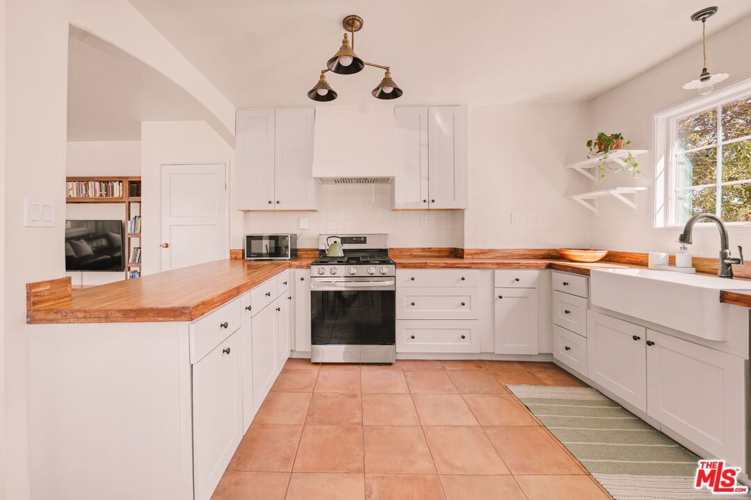 592 Figueroa Drive Altadena, CA 91001 - Photo 7 of 19 a kitchen with cabinets appliances and a window
