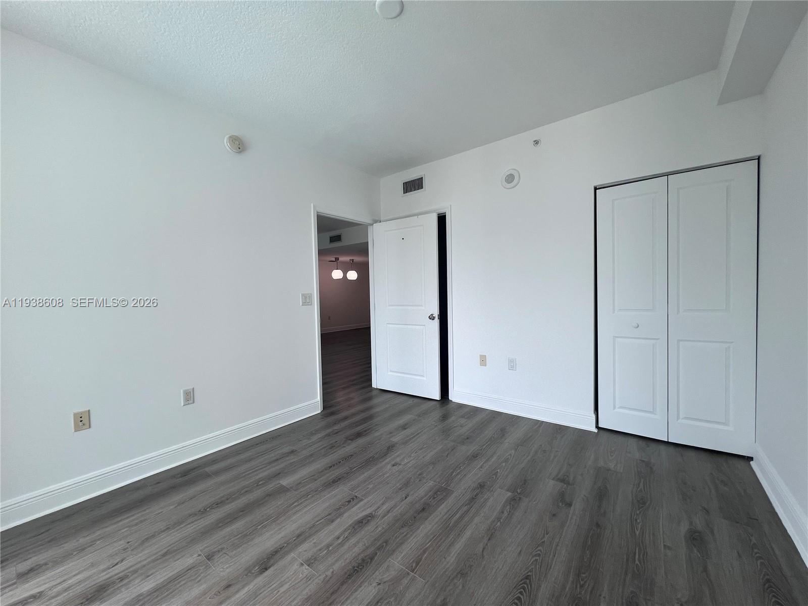 1250 South Miami Avenue, Unit 2104 Miami, FL 33130 - Photo 13 of 18 a view of an empty room with wooden floor