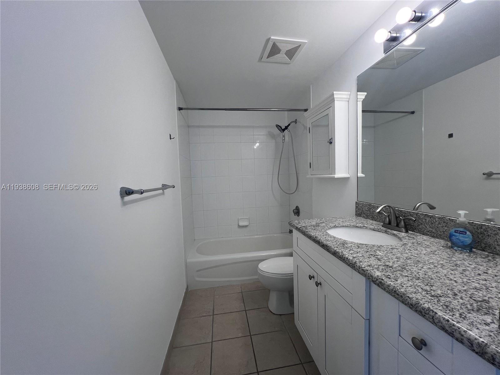 1250 South Miami Avenue, Unit 2104 Miami, FL 33130 - Photo 16 of 18 a bathroom with a granite countertop sink a toilet and shower