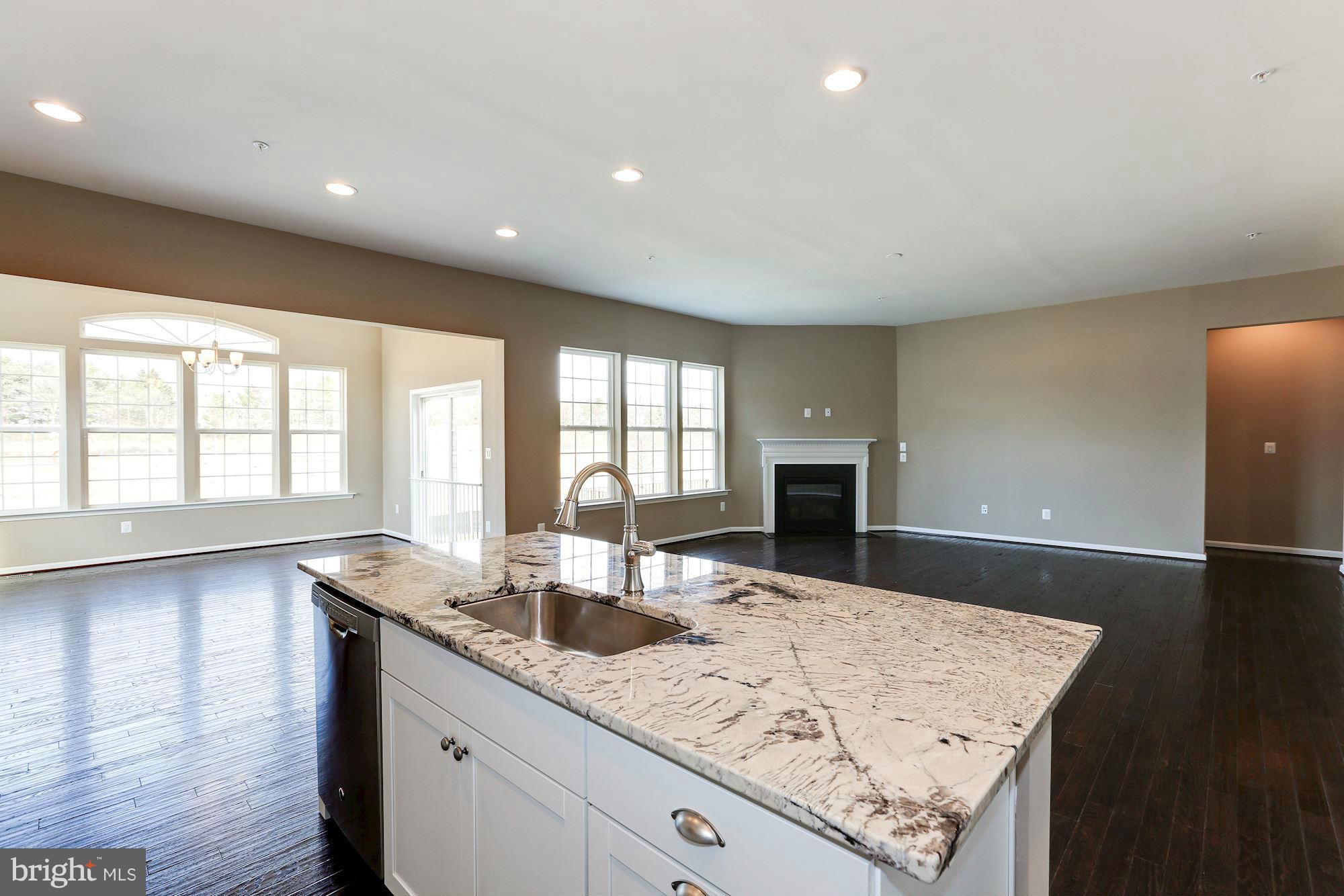 925 Lindley Road Frederick, MD 21701 - Photo 11 of 30 a view of a kitchen counter top space with granite countertop wooden floor and a sink