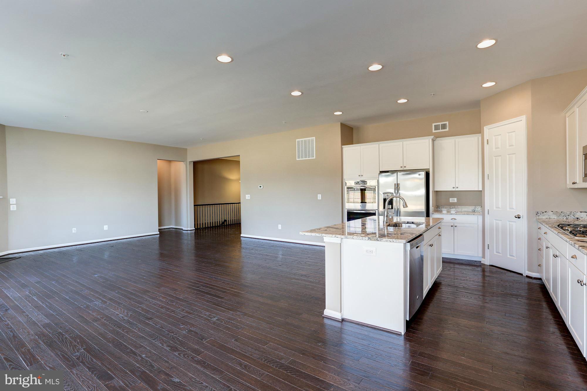 925 Lindley Road Frederick, MD 21701 - Photo 12 of 30 a kitchen with stainless steel appliances a sink stove and wooden floor