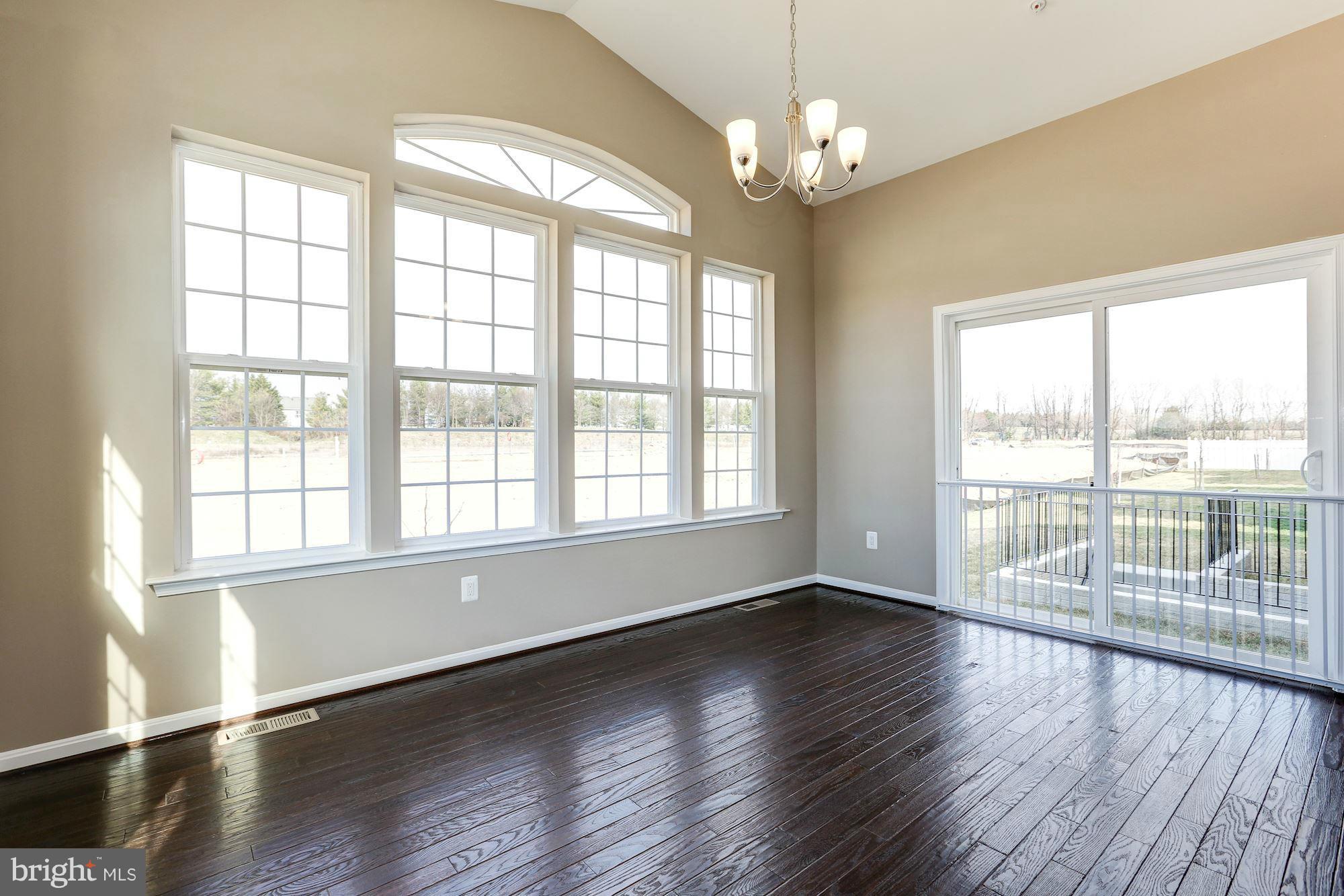 925 Lindley Road Frederick, MD 21701 - Photo 13 of 30 a view of an empty room with wooden floor and a window