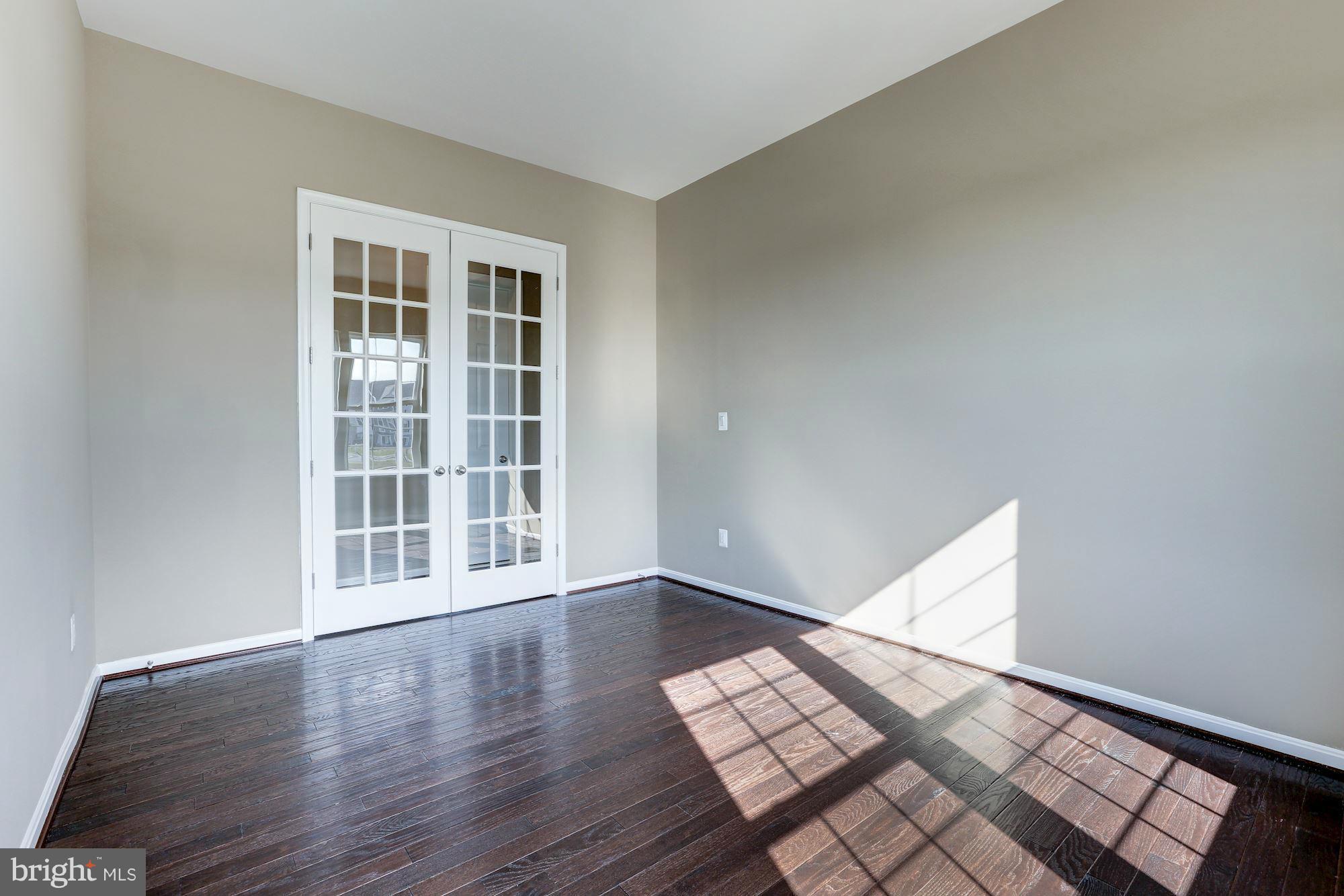 925 Lindley Road Frederick, MD 21701 - Photo 22 of 30 a view of an empty room with wooden floor and windows