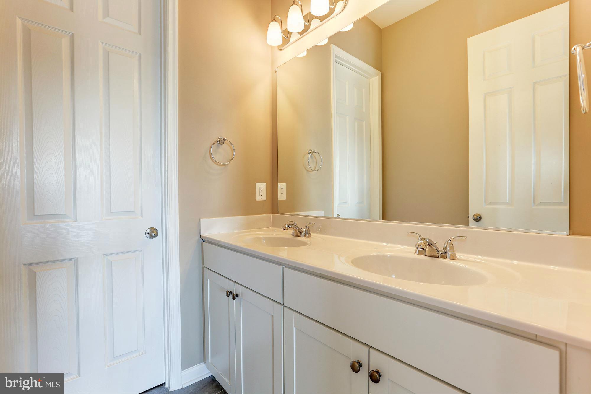 925 Lindley Road Frederick, MD 21701 - Photo 23 of 30 a bathroom with a double vanity sink and a mirror