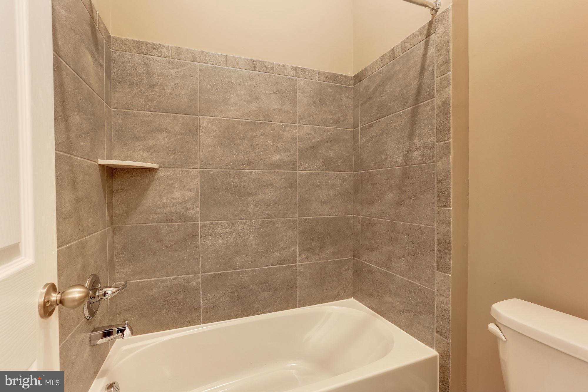 925 Lindley Road Frederick, MD 21701 - Photo 24 of 30 a bath tub sitting next to a white toilet