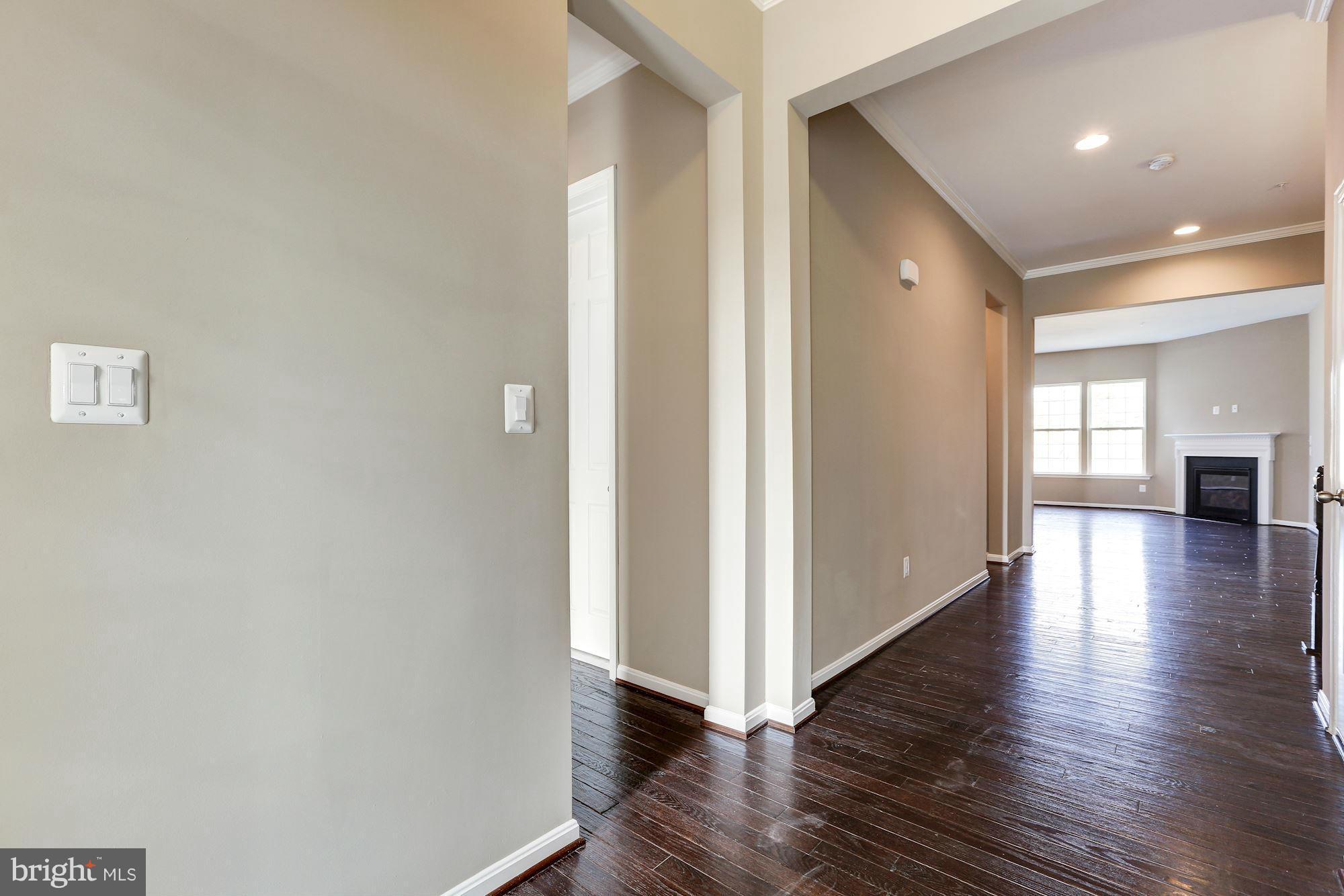 925 Lindley Road Frederick, MD 21701 - Photo 4 of 30 a view of a hallway view with wooden floor and staircase