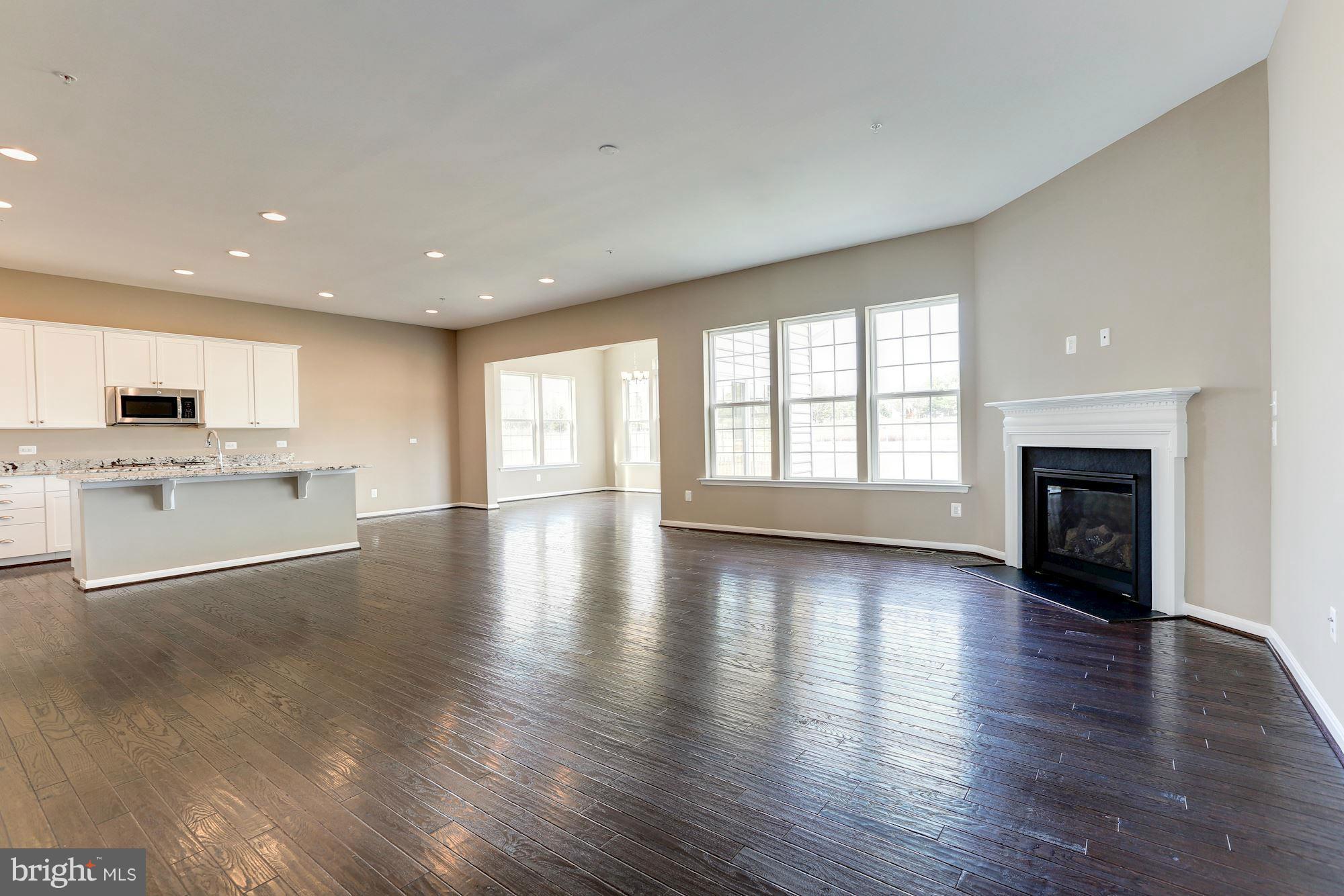 925 Lindley Road Frederick, MD 21701 - Photo 7 of 30 a view of an empty room with a fireplace and wooden floor