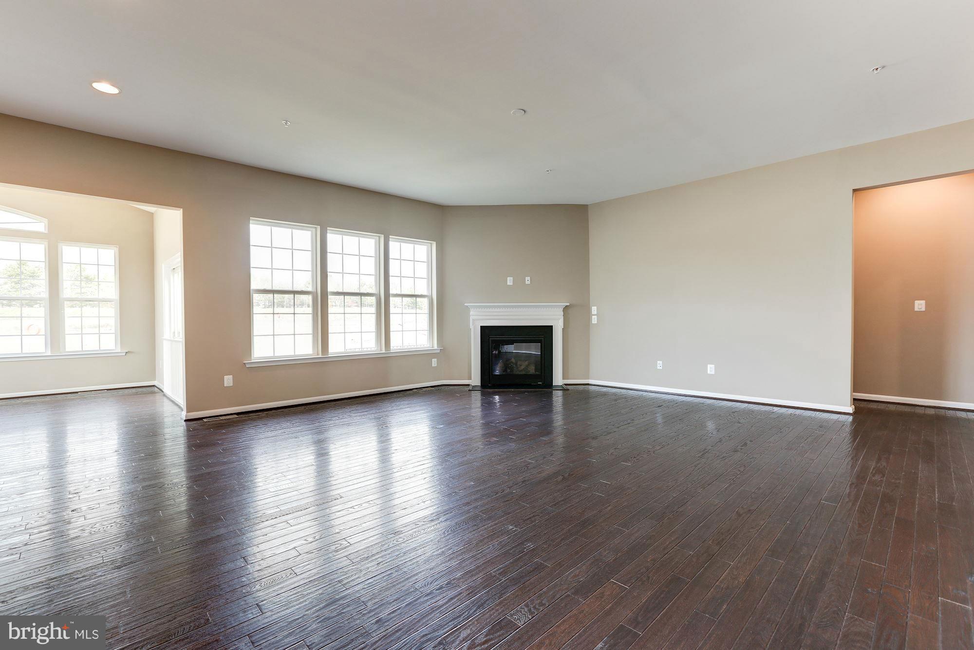 925 Lindley Road Frederick, MD 21701 - Photo 8 of 30 an empty room with wooden floor and windows