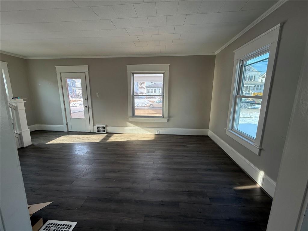 1056 Adams Street New Castle, PA 16101 - Photo 5 of 10 an empty room with wooden floor and windows
