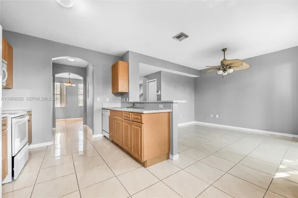 a large kitchen with a sink and cabinets
