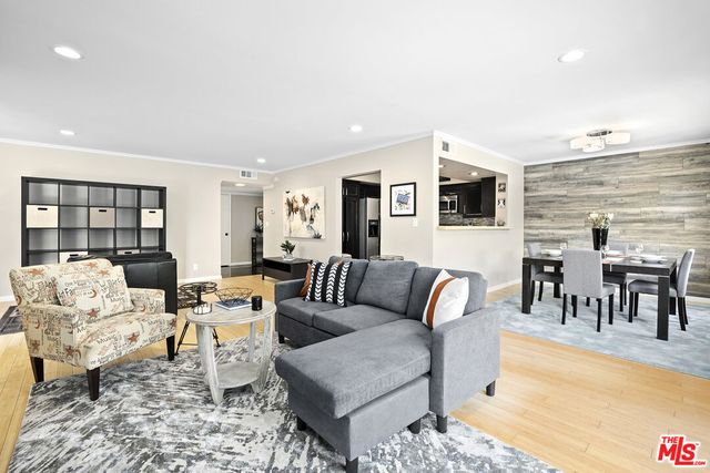 a living room with furniture wooden floor and a rug