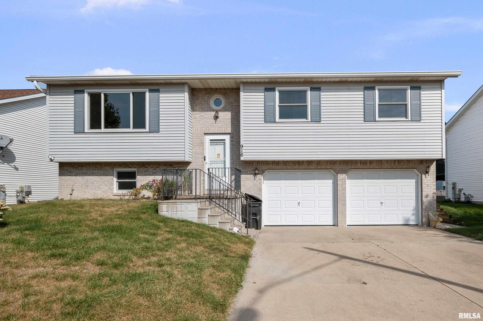 916 Ash Drive Colona, IL 61241 - Photo 1 of 38 a house view with a outdoor space
