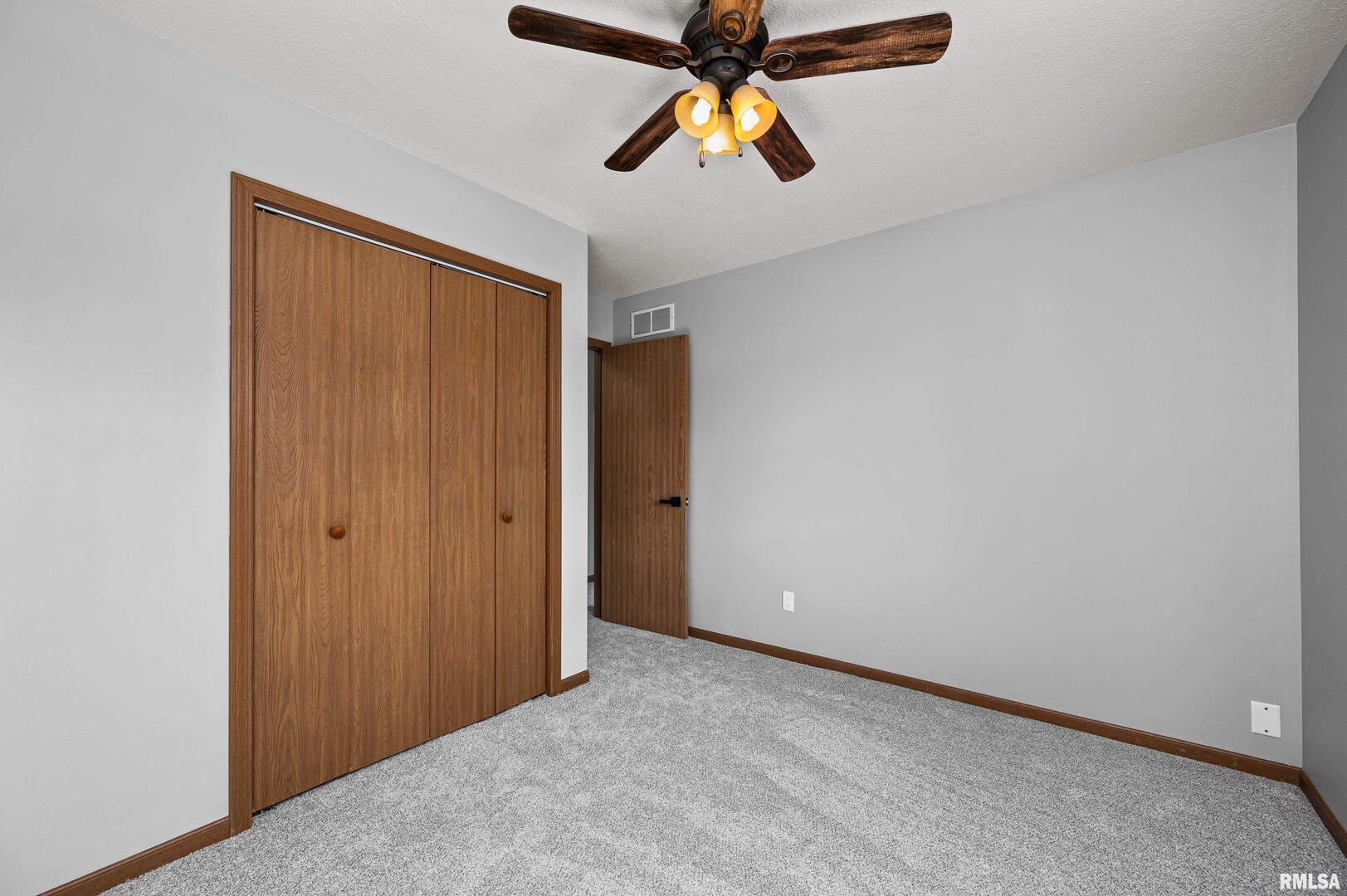 916 Ash Drive Colona, IL 61241 - Photo 16 of 38 an empty room with closet and window