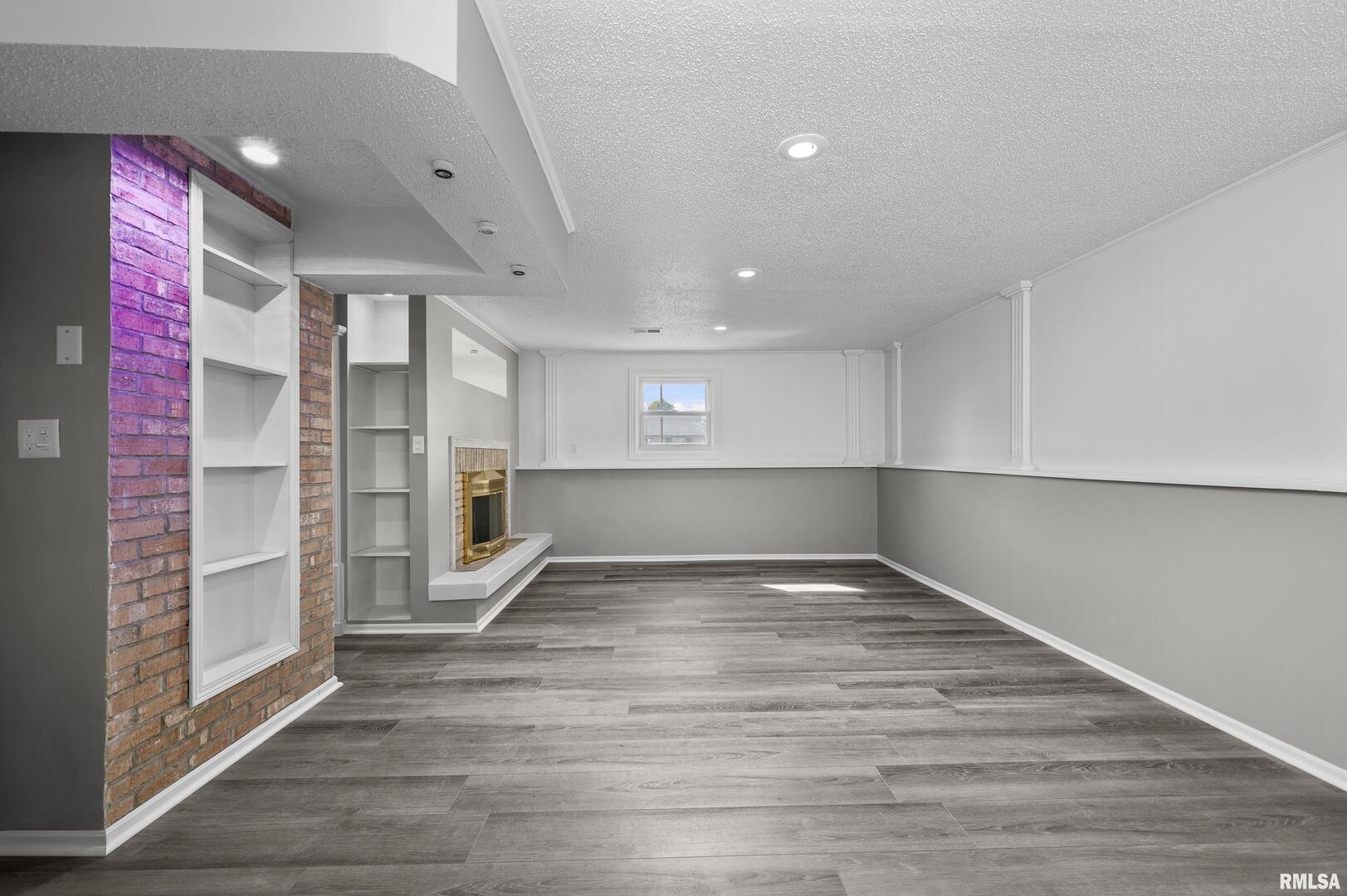 916 Ash Drive Colona, IL 61241 - Photo 24 of 38 a view of an empty room with wooden floor and a window