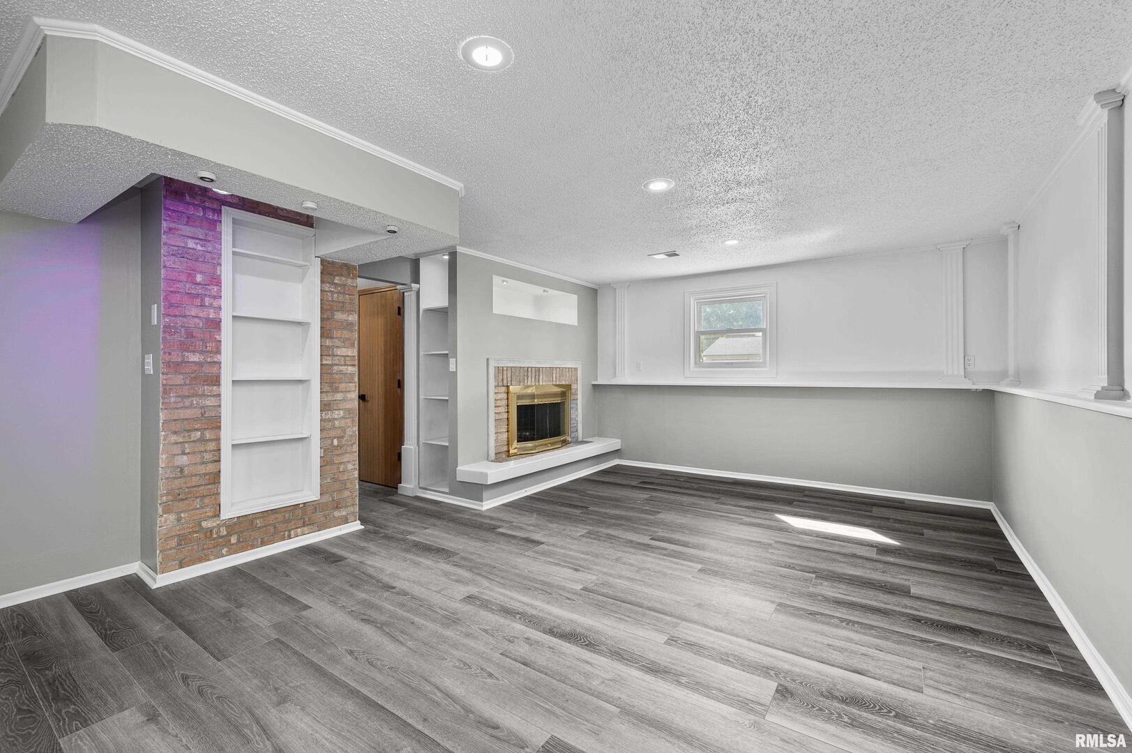 916 Ash Drive Colona, IL 61241 - Photo 25 of 38 an empty room with wooden floor cabinet and windows