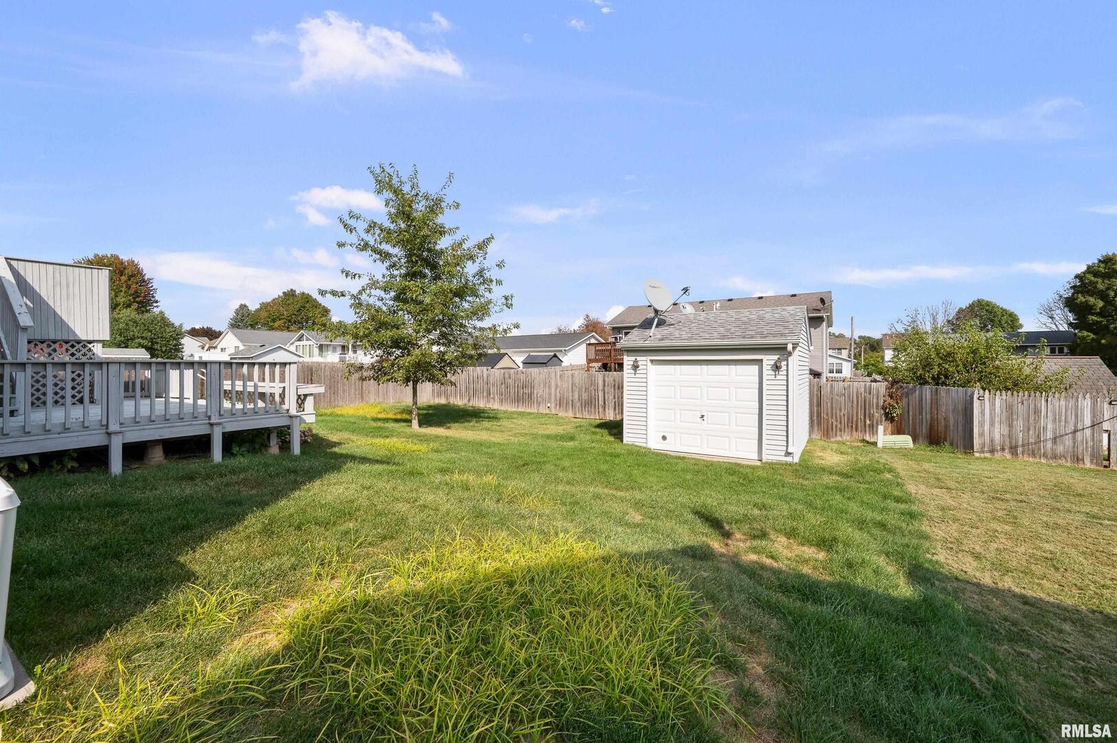 916 Ash Drive Colona, IL 61241 - Photo 34 of 38 a view of a house with a yard and sitting area