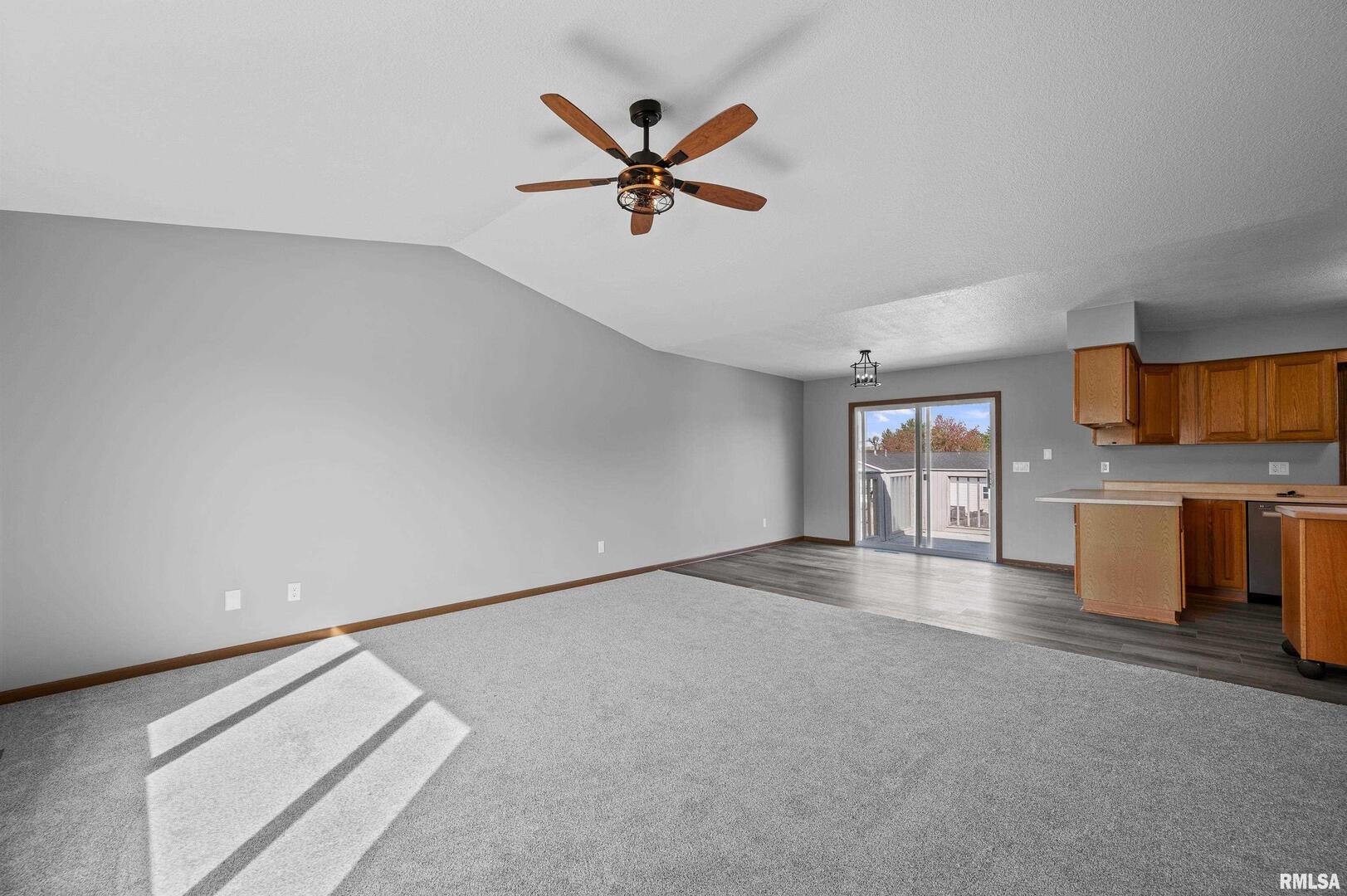 916 Ash Drive Colona, IL 61241 - Photo 5 of 38 a view of a livingroom with a ceiling fan and window