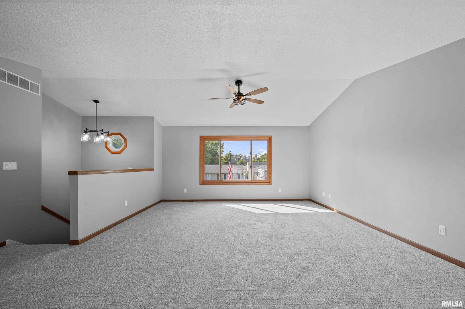 916 Ash Drive Colona, IL 61241 - Photo 6 of 38 an empty room with windows and closet