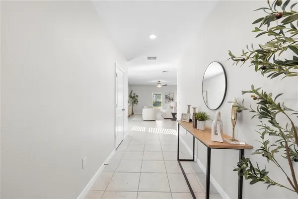 a living room with couches and kitchen view with kitchen view