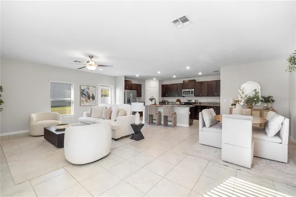 a living room with furniture and a potted plant