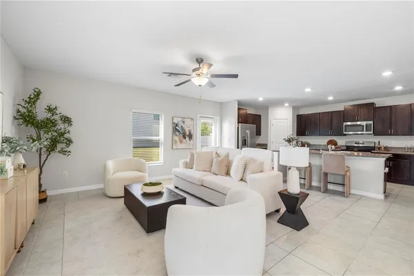 a kitchen with a sink a counter top space appliances and cabinets